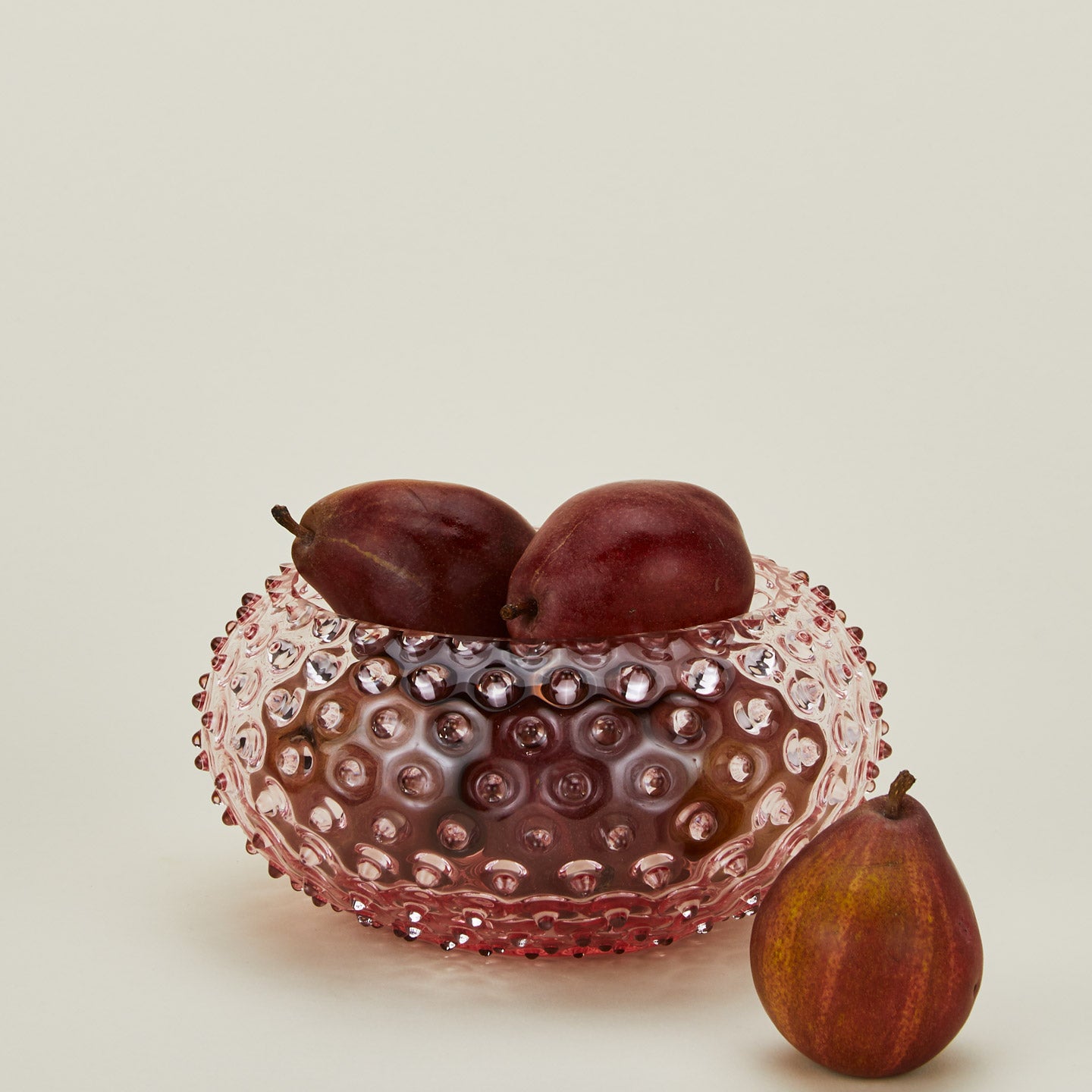 Glass hobnail blush serving bowl with pears.