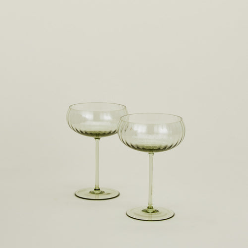 Set of two ribbed olive coupe glasses.