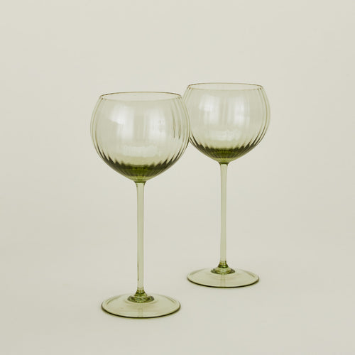Set of two ribbed olive wine glasses.