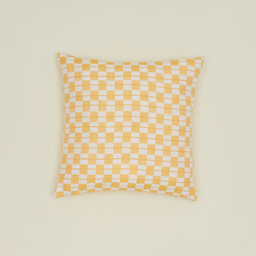 Quilted checkered pillow in yellow and white.