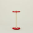 A red and yellow paper towel holder.