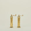 A pair of brass salt and pepper mills.