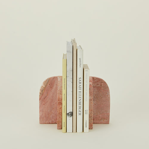 Red travertine book ends with books