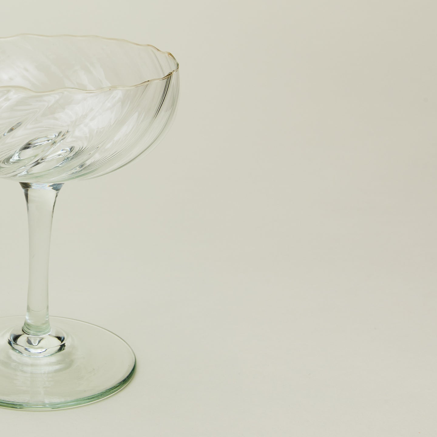 Close up view of Bow glassware coupe in optic