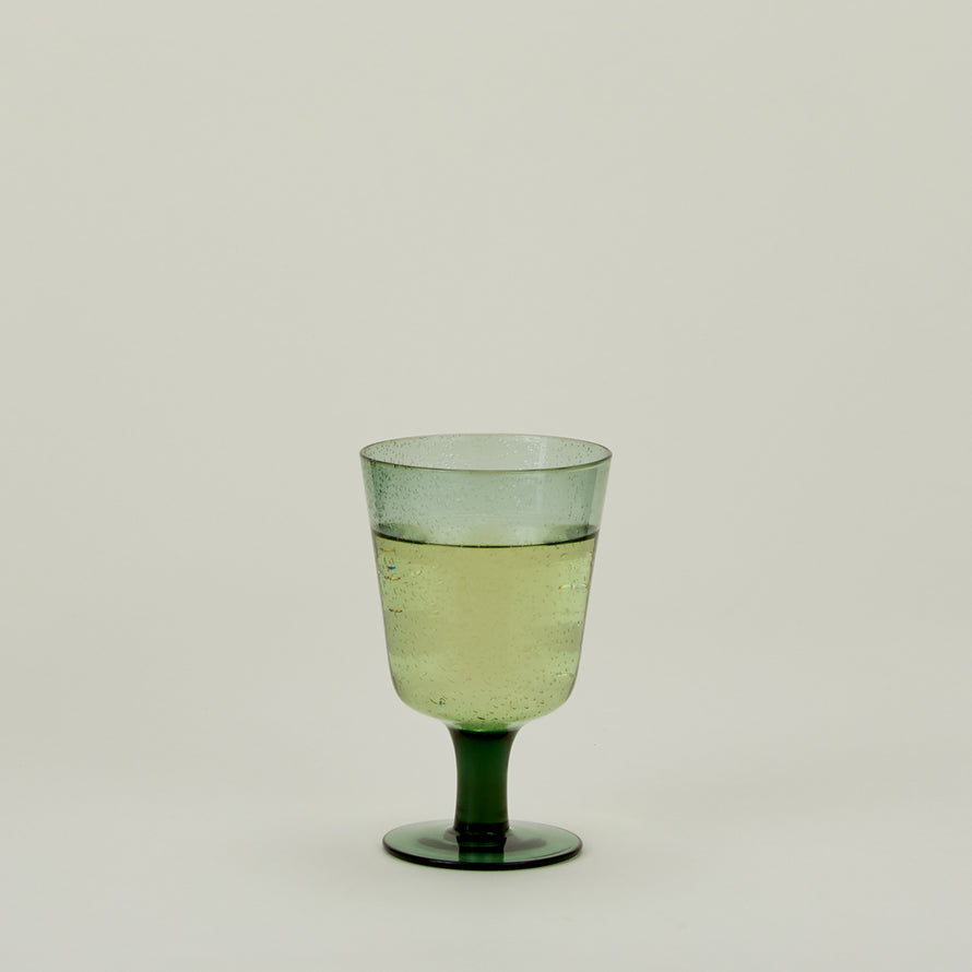 Stemmed Wine Glass in Jade, filled with water.