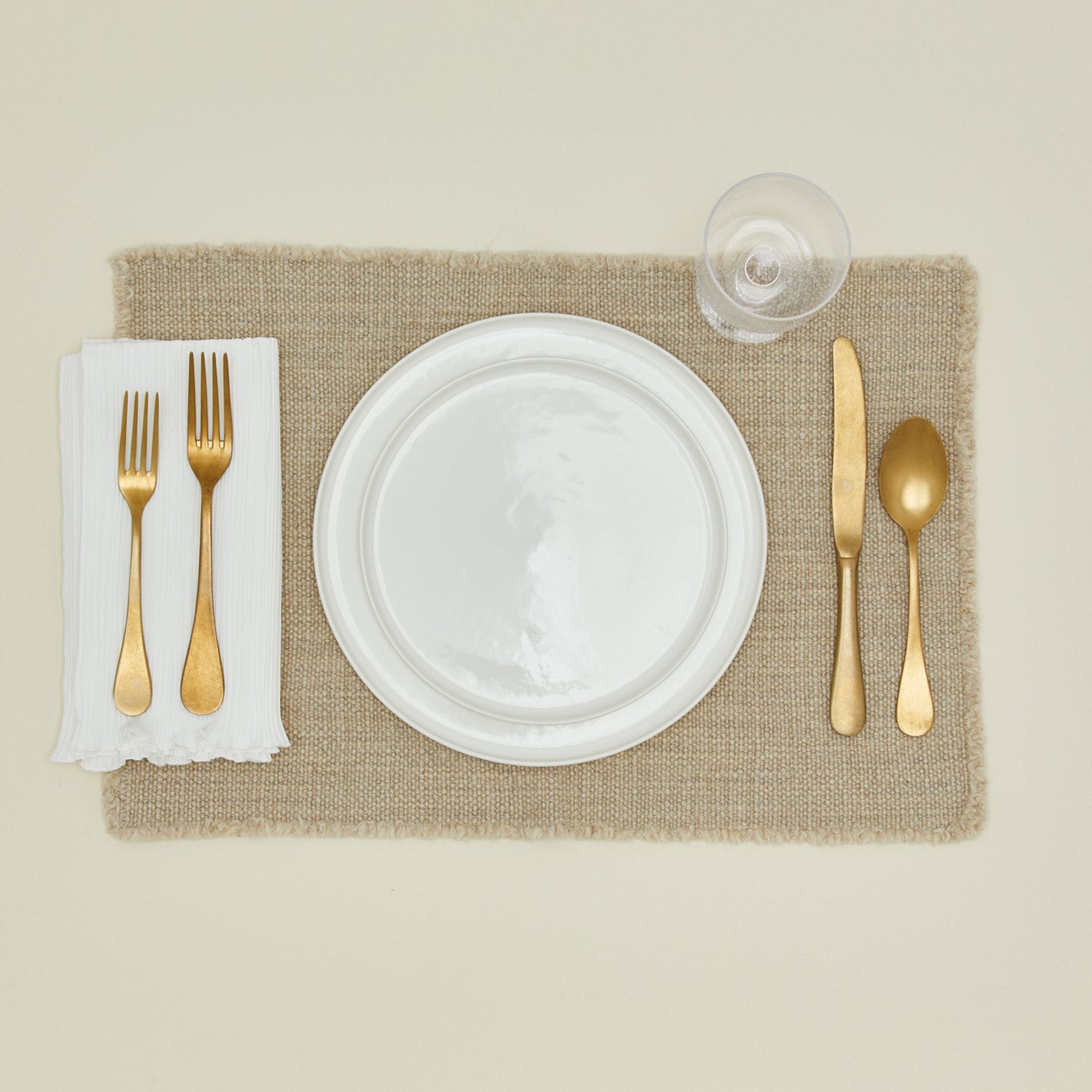 Cahaya pleated napkin in ivory with place setting and placemat