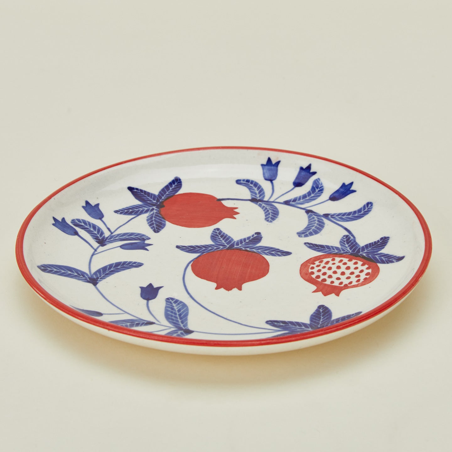 Detailed view of Casa Amarosa pomegranate plate