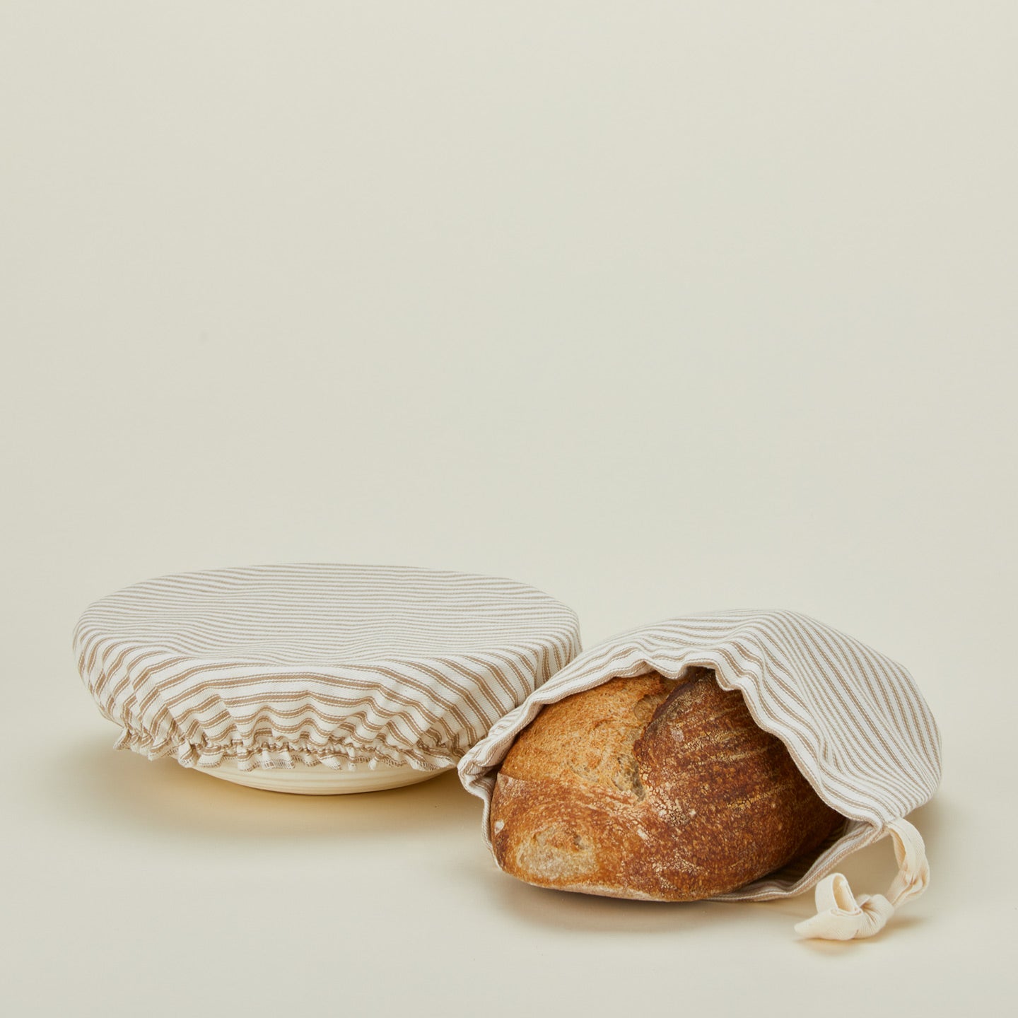 Dot and Army bread bag and bowl cover with loaf of bread.