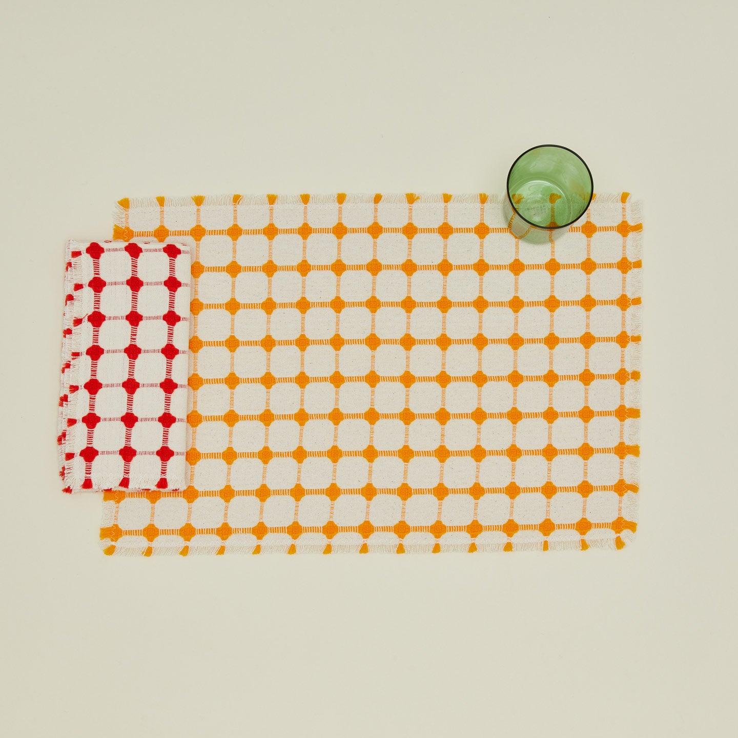 Dove and Donkey wicker fringed napkin in cherry with placemat and glass