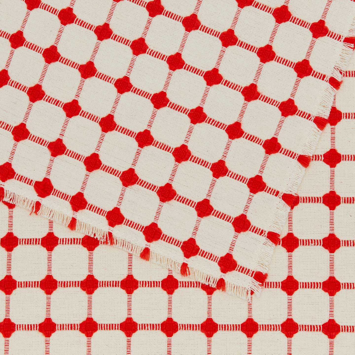Close up view of Dove and Donkey wicker fringed placemat in cherry