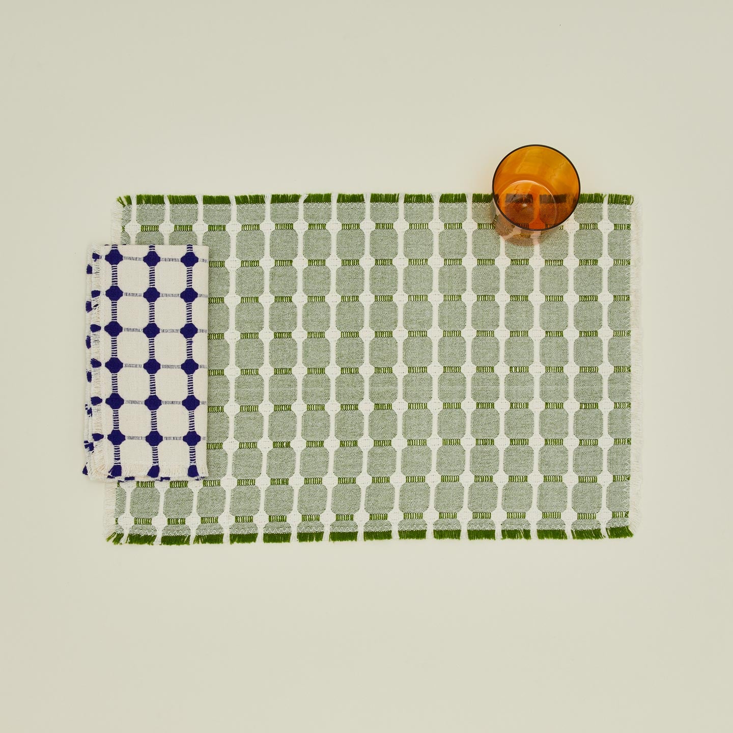 Dove and Donkey Wicker Fringed Napkin  in cobalt with Hopsack placemat and terracotta essential glass