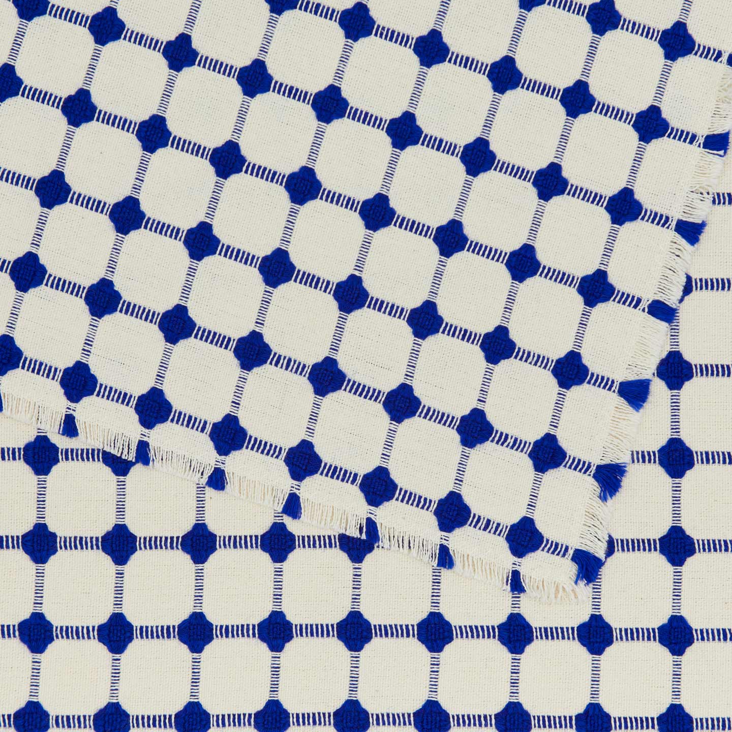 Close up view of Dove and Donkey wicker fringed placemat in cobalt