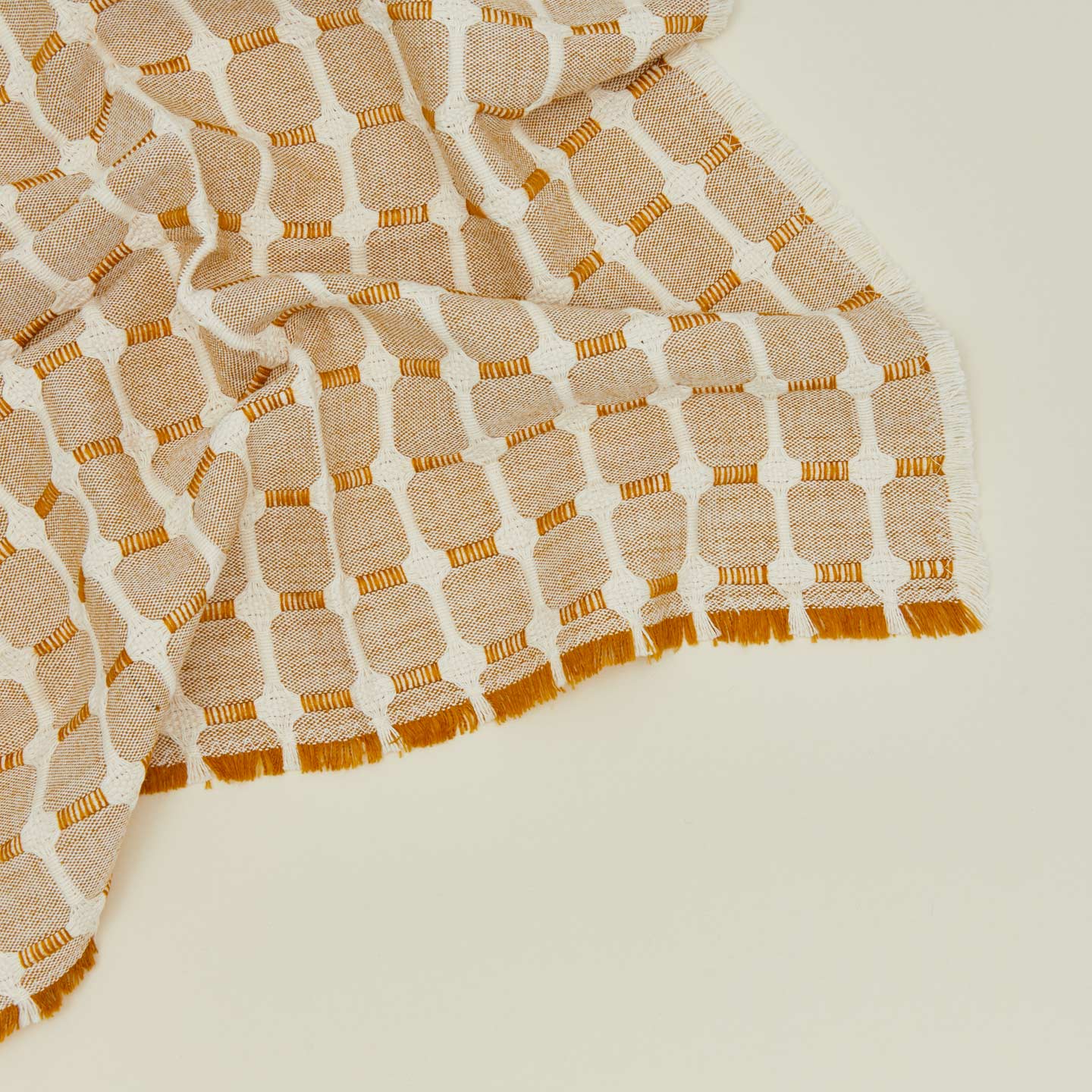 Close up view of Dove and Donkey hopsack napkin in honey