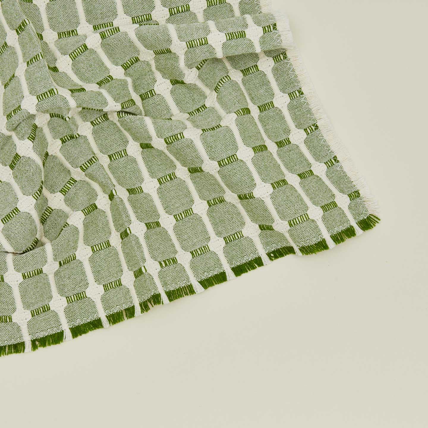Close up view of Dove and Donkey hopsack napkin in leaf