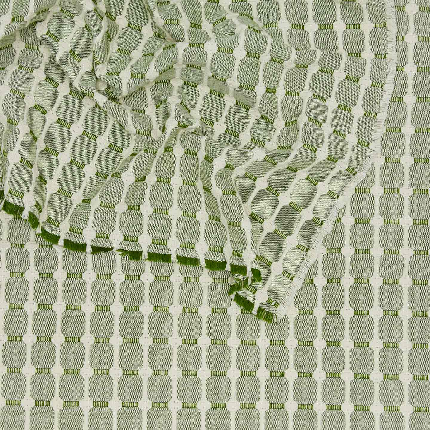 Close up view of Dove and Donkey hopsack tablecloth in leaf