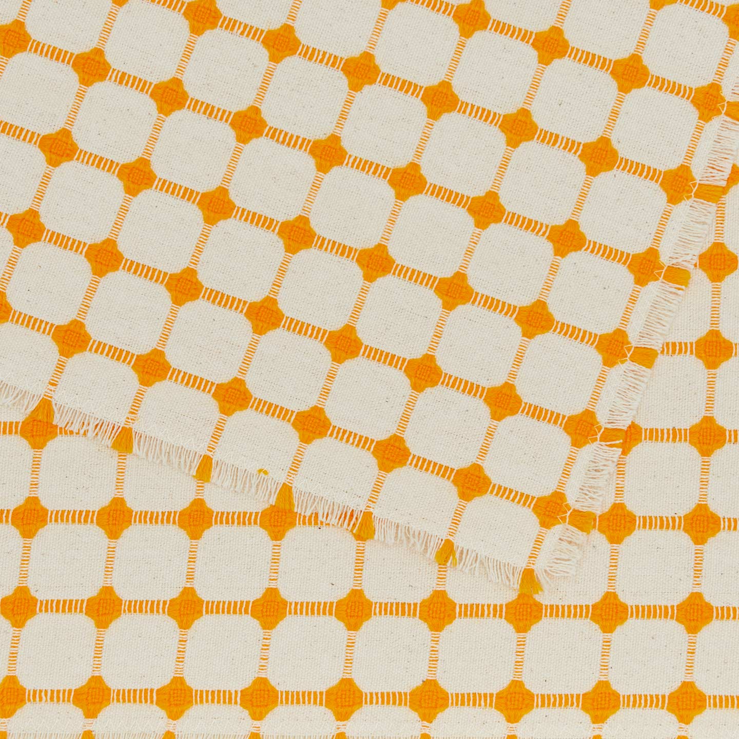 Close up view of Dove and Donkey wicker fringed placemat in marigold