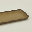 Close up view of stoneware wavy tray in olive