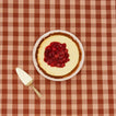 Essential pie dish with cheesecake on gingham background