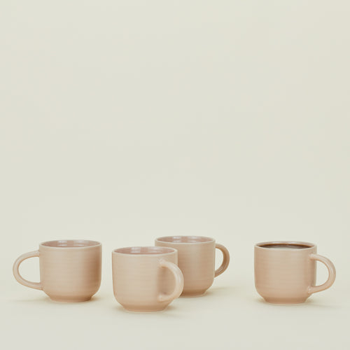Four Essential Mugs in Blush, with coffee.