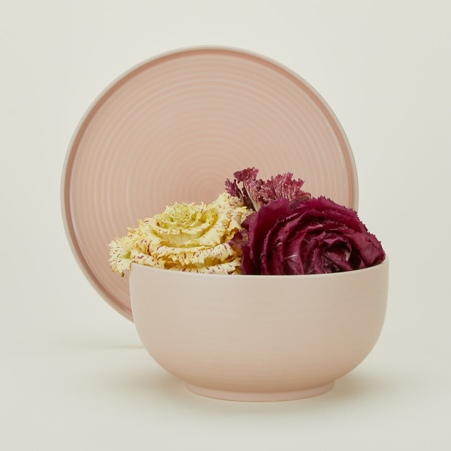 Essential Serving Bowl and Serving Platter in Blush, with lettuces.