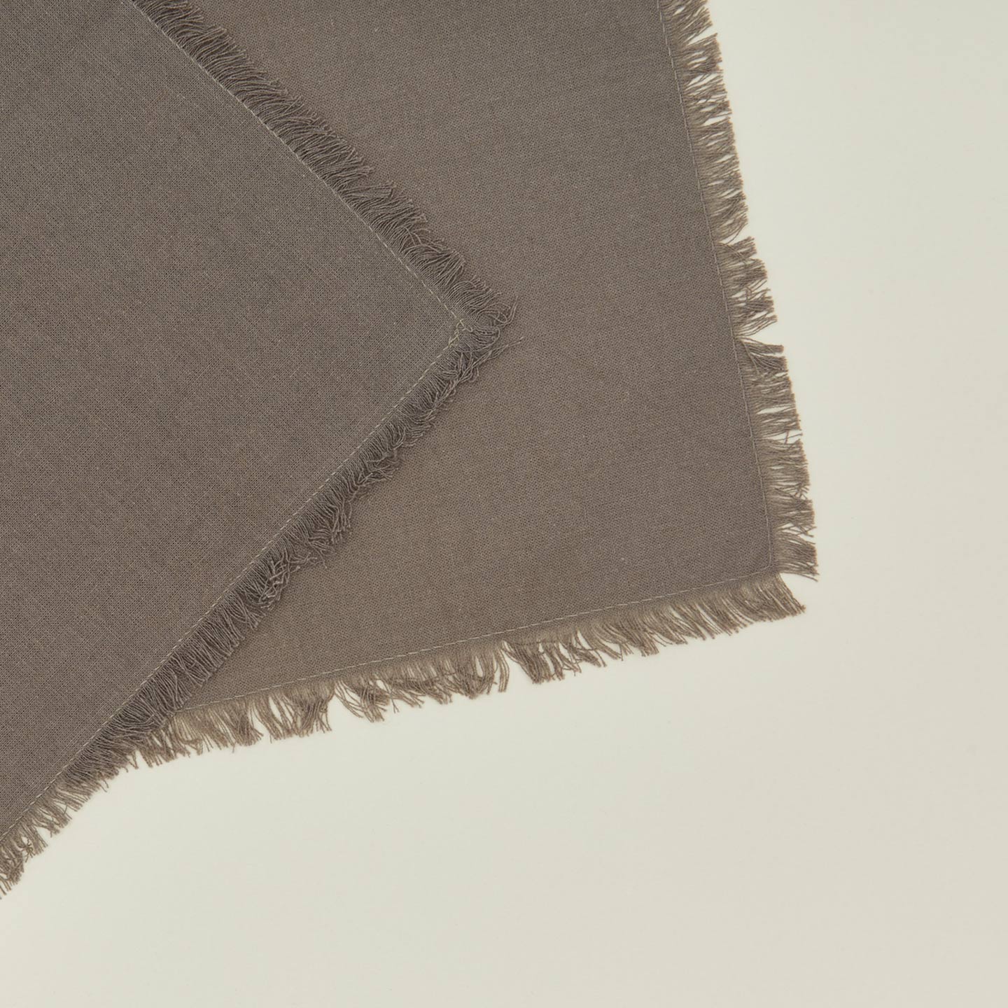 Close up view of essential cocktail napkin in dark grey