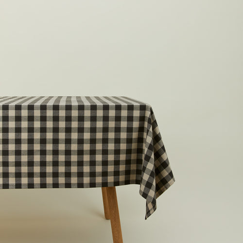 Essential Gingham tablecloth in grey/black on a table.