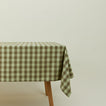 Essential Gingham tablecloth in sage/olive on a table.