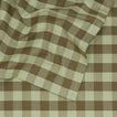 Close up view of Essential Gingham tablecloth in sage/olive