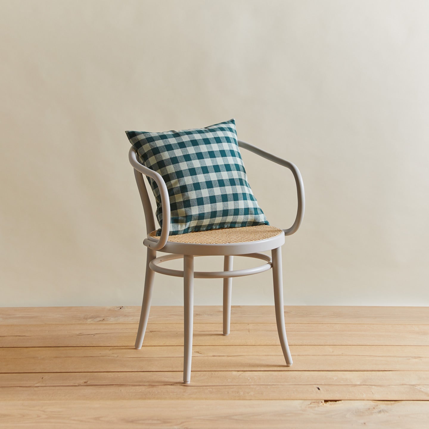 Sky/Peacock Gingham pillow on a chair