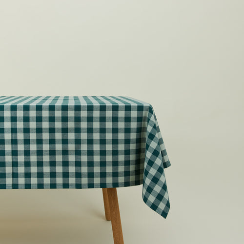 Essential Gingham tablecloth in sky/peacock on a table.