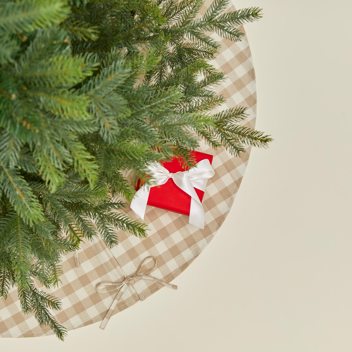 Overhead view of Essential GIngham Tree Skirt - Ivory/Flax with tree