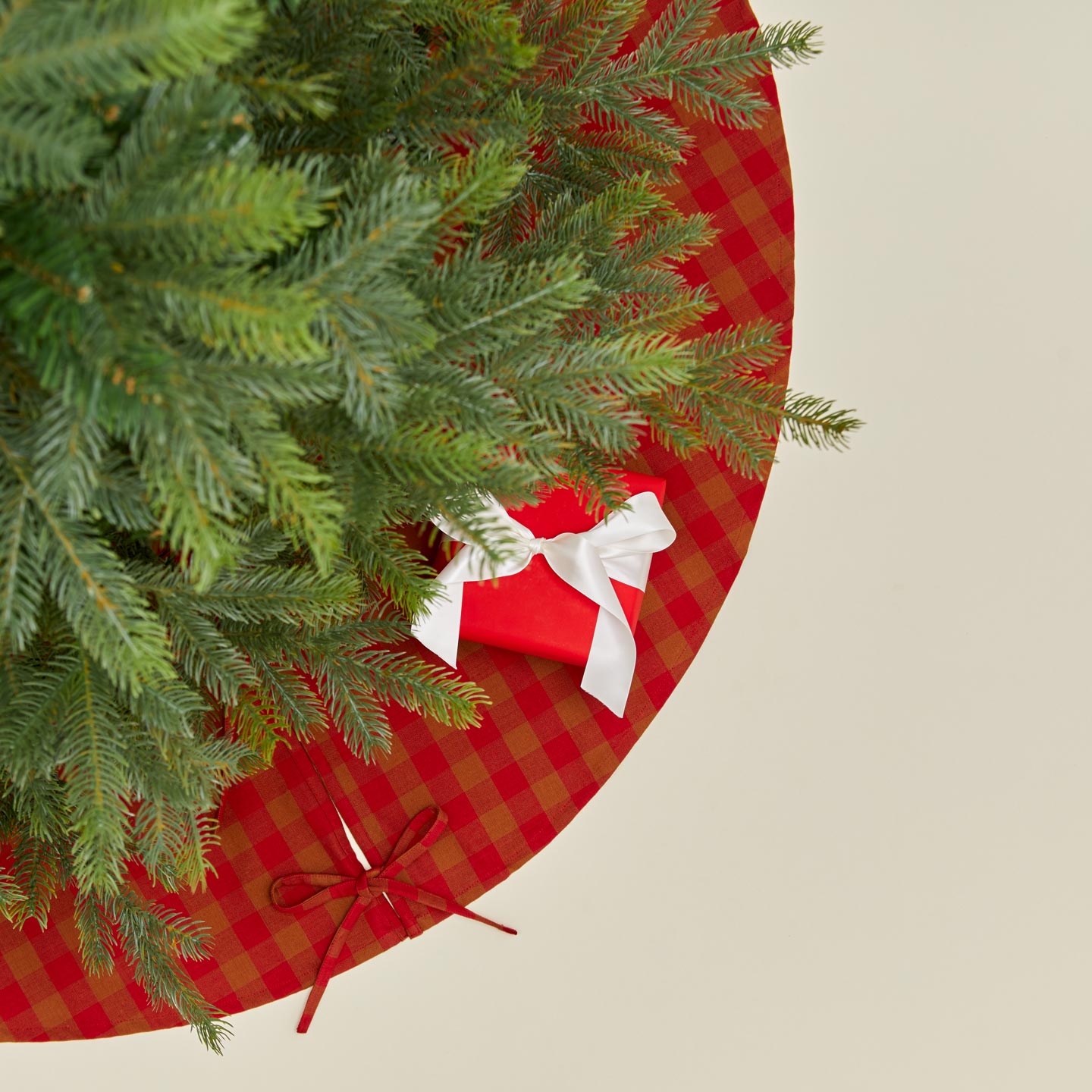 Overhead view of Essential GIngham Tree Skirt - Terracotta/Red with tree