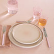 Placesetting with Essential Glassware in Blush on pink tablecloth.