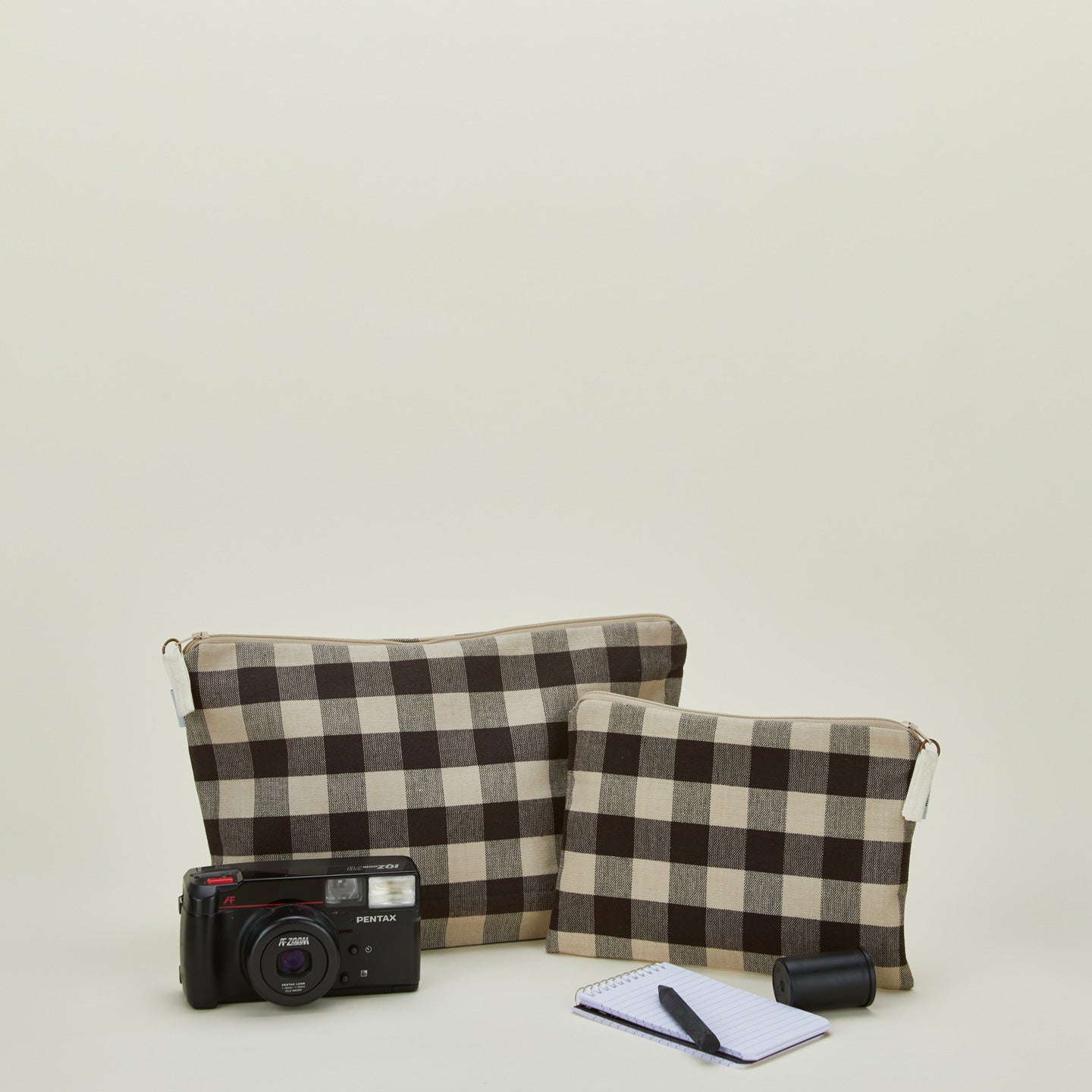 Essential gingham pouches in light grey and black with camera and notepad