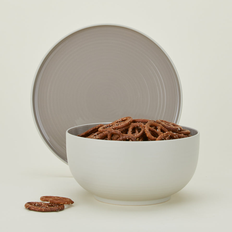 Essential Serving Bowl and Serving Platter in Light Grey, with pretzels.