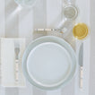Placesetting with Essential Dinner Napkin in Ivory on ivory striped tablecloth.