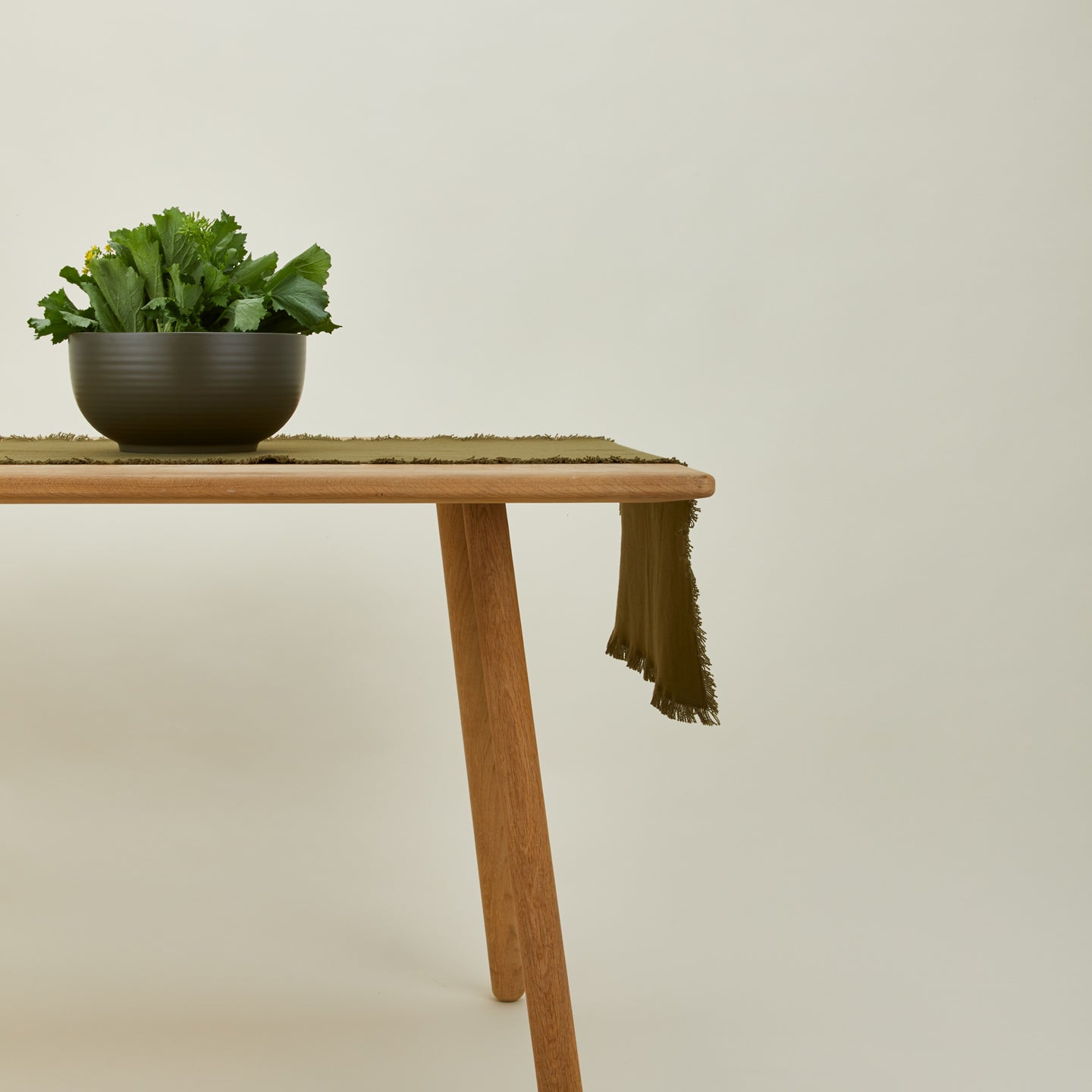 Essential olive runner on table with serving bowl