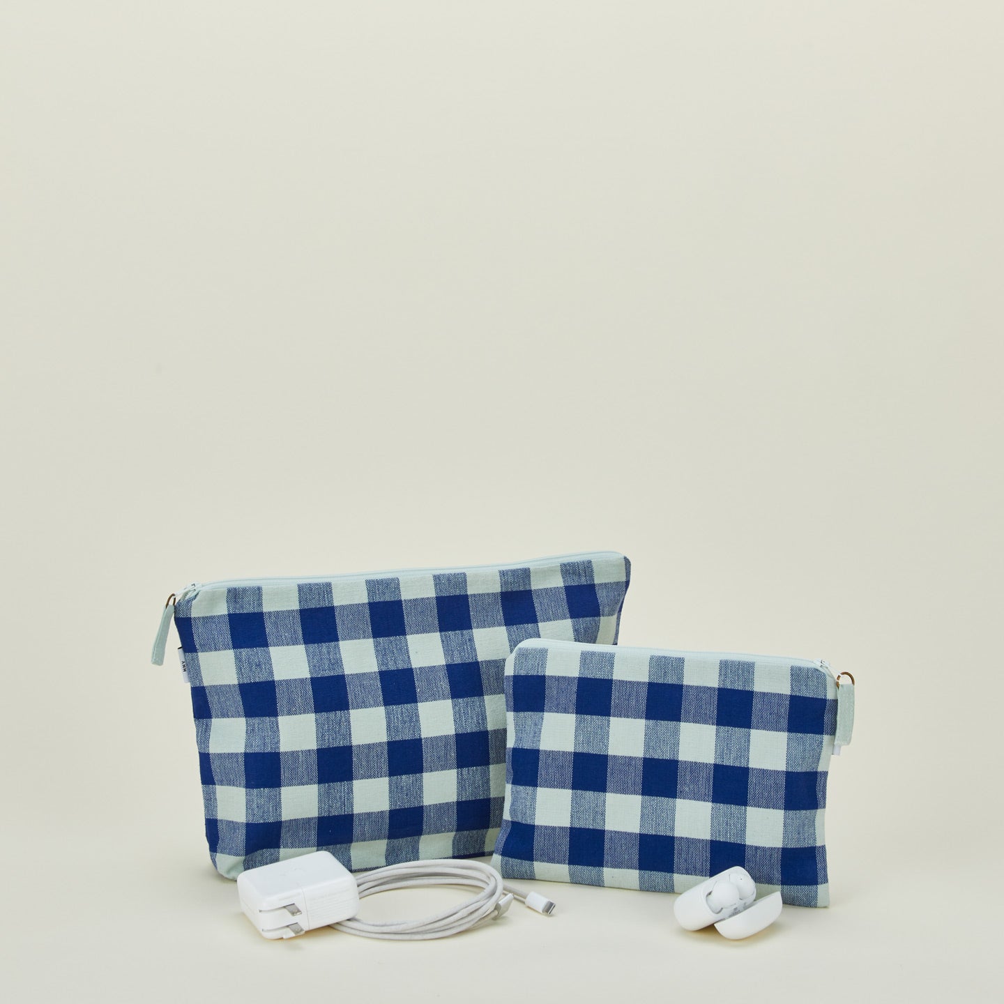 Essential gingham pouches in sky and blue with charger and earbuds