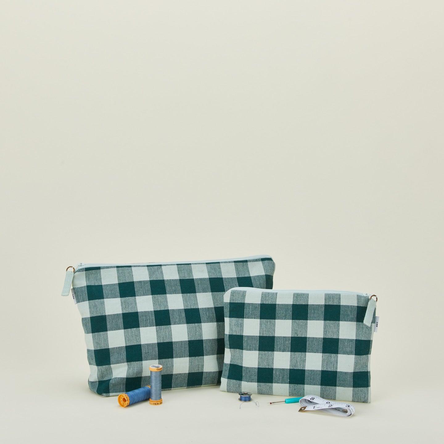 Essential gingham pouches in sky and peacock with thread and sewing notions