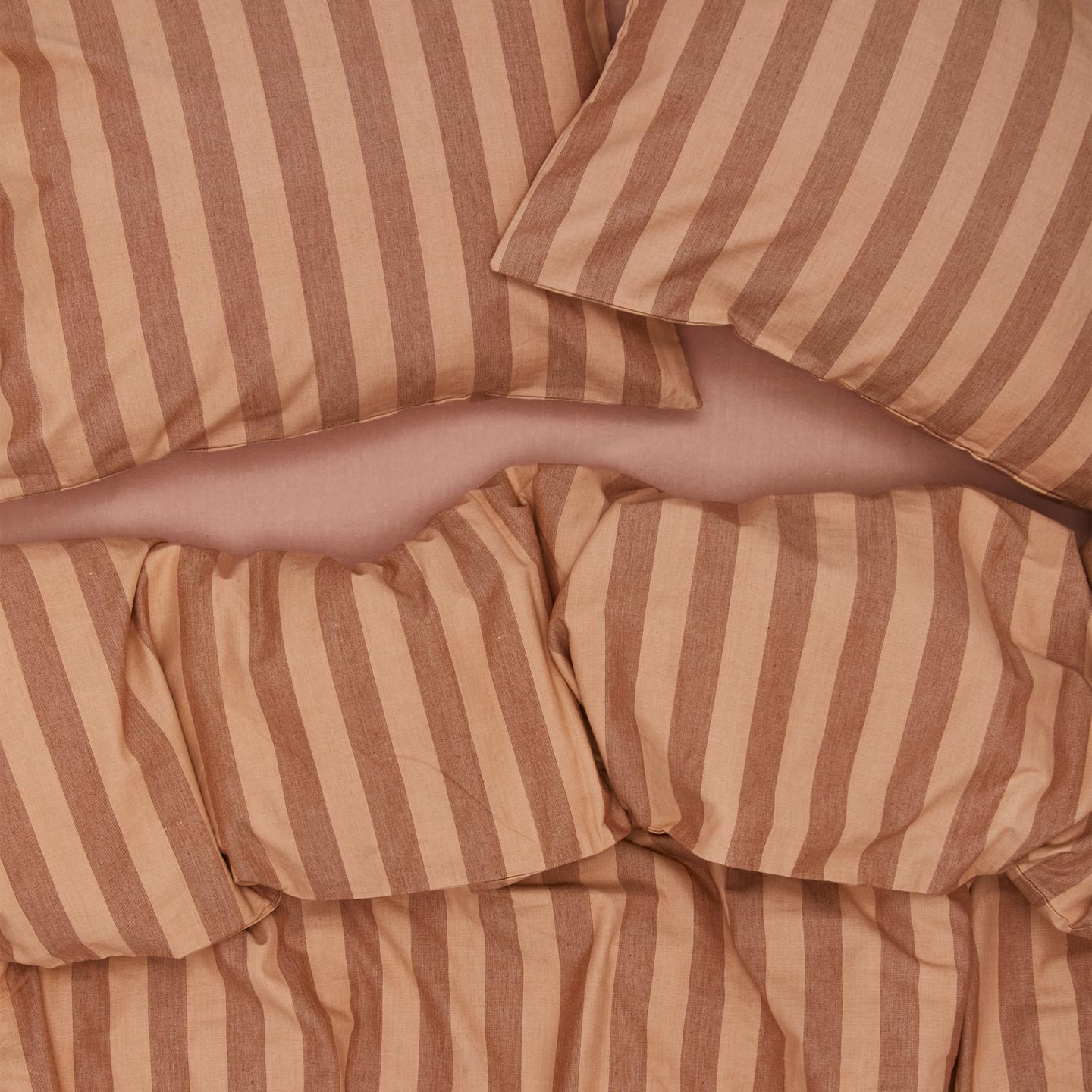 Essential Stripe Pillowcases, Set of 2 - Blush/Terracotta on bed with matching duvet