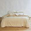 Essential Stripe Pillowcases, Set of 2 - Ivory/Flax on bed with matching duvet