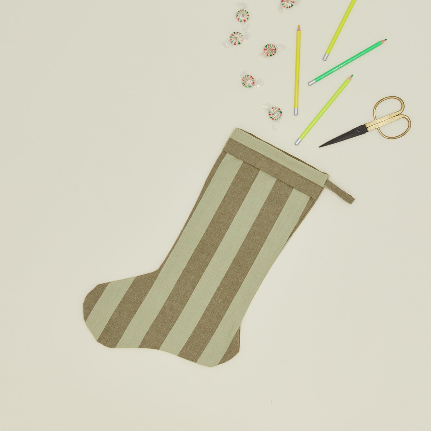 Essential Striped Stocking - Olive/Sage with scissors, pencils, and candy