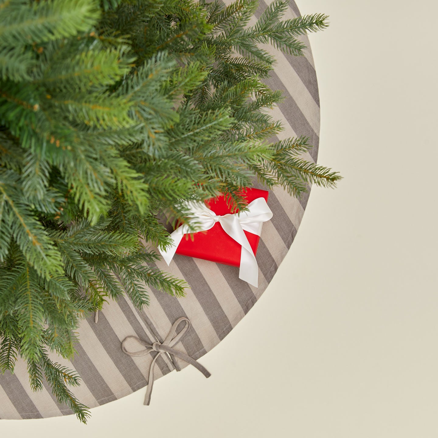 Overhead view of Essential Striped Tree Skirt - Light Grey/Dark Grey with tree