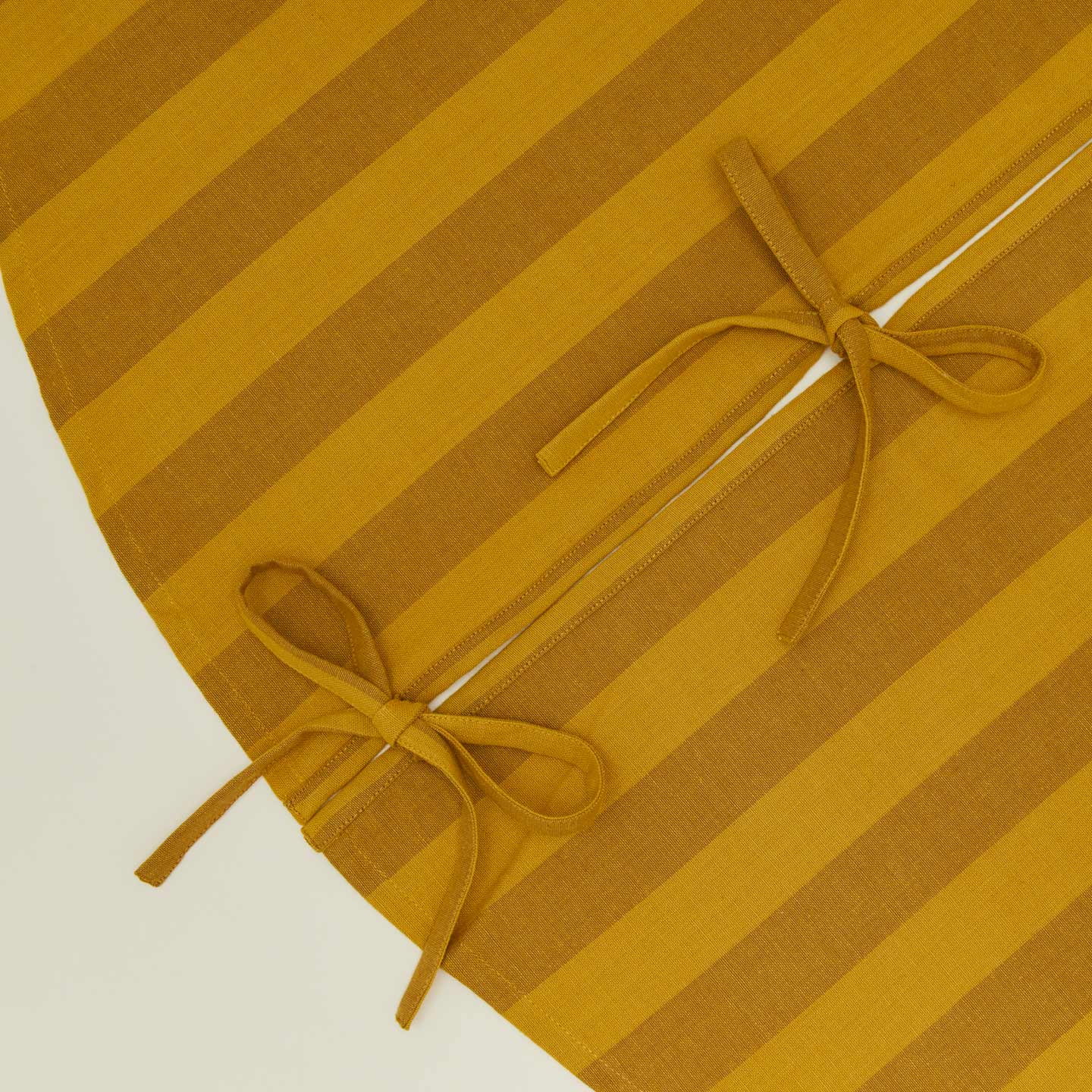 Detailed view of Essential Striped Tree Skirt - Mustard/Bronze