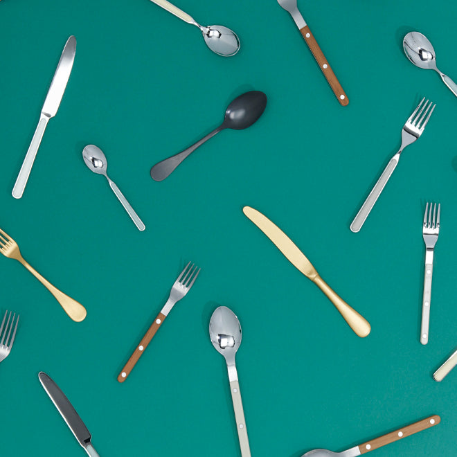assorted flatware on green background