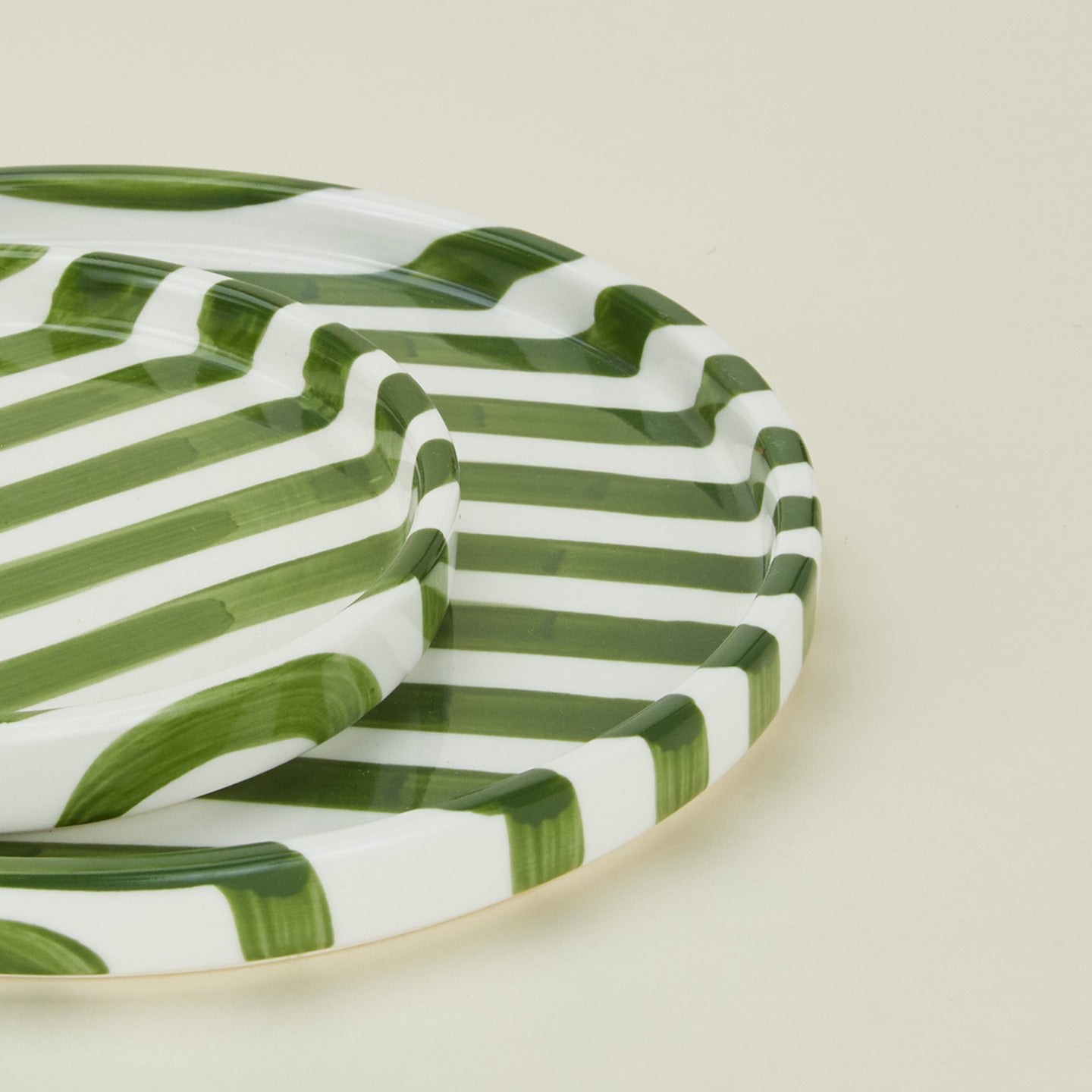 Detailed view of Fodory olive striped plates