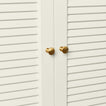 Small brass knobs on cabinet doors