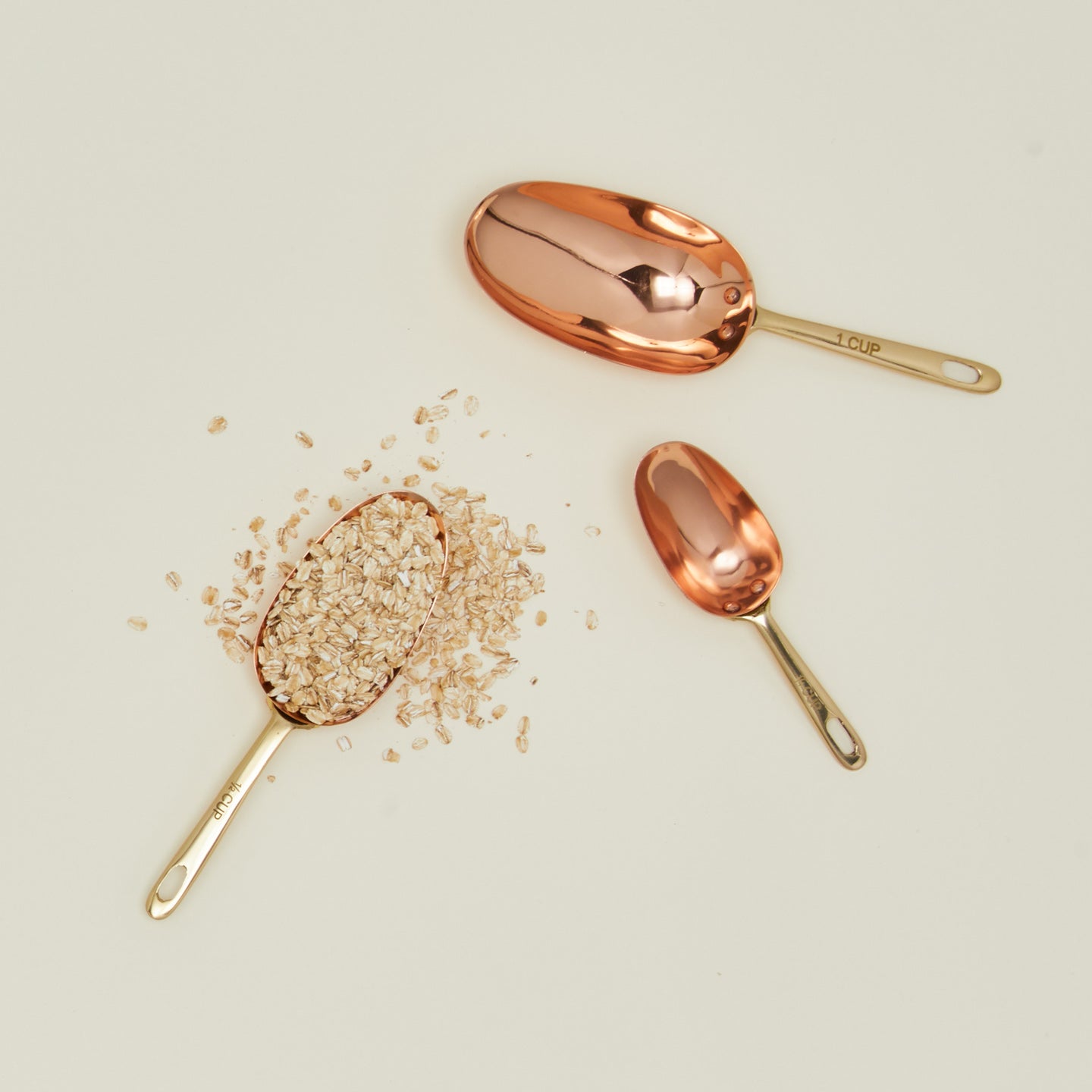 Copper measuring scoops with oats