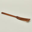 Detailed view of Narrow teak slotted spatula