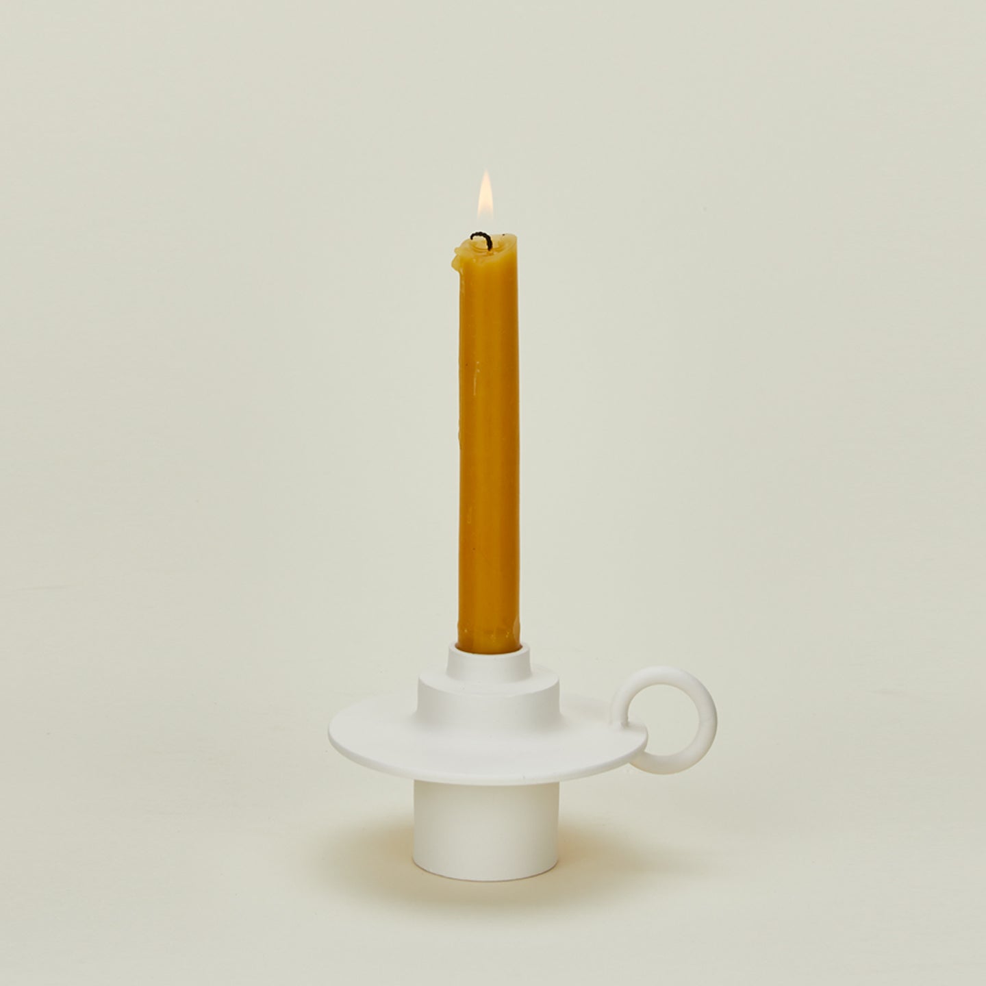 Foundry Candlestick with lit candle 